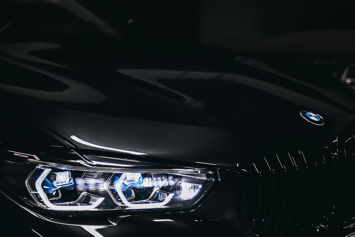 Close view of a laser headlight and black grille on a dark BMW