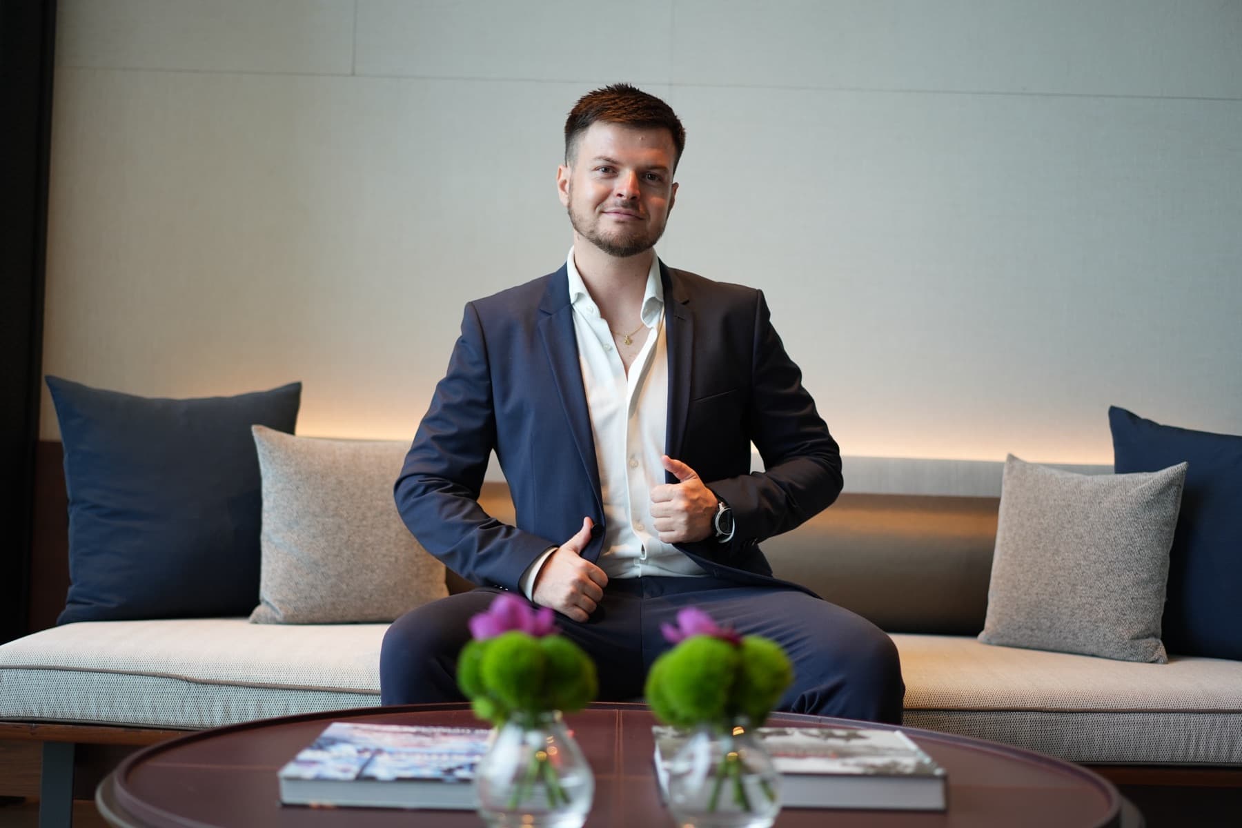 Arthur, sitting, in a dark blue suit, in Bangkok